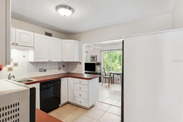 kitchen with black dishwasher, a sink, white cabinets, tasteful backsplash, and a textured ceiling
