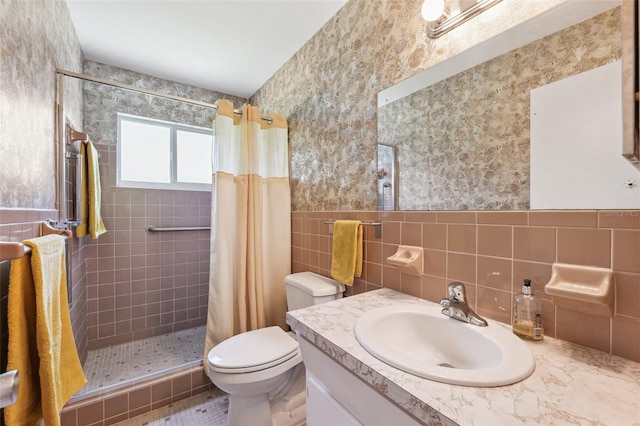 full bathroom featuring toilet, a shower stall, tile walls, vanity, and wallpapered walls