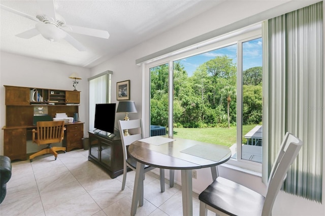 dining space featuring a desk, light tile patterned floors, and a ceiling fan