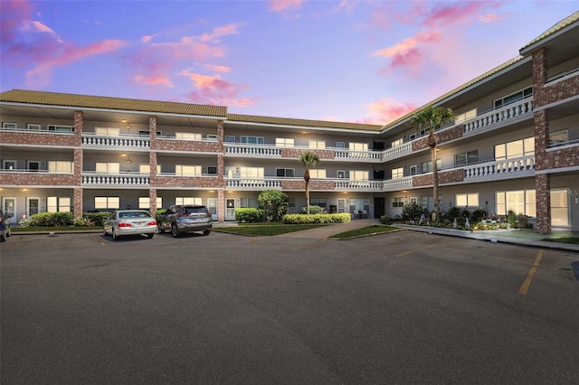 view of building exterior featuring uncovered parking