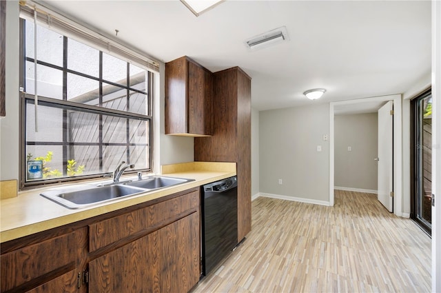 4006 Cypress Ln Unit 4006, Tampa, FL 33618 - kitchen with dishwasher, a sink, light countertops, light wood-style flooring, and healthy amount of natural light