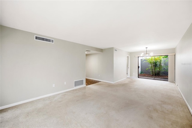 4006 Cypress Ln Unit 4006, Tampa, FL 33618 - spare room featuring a chandelier, baseboards, and carpet flooring