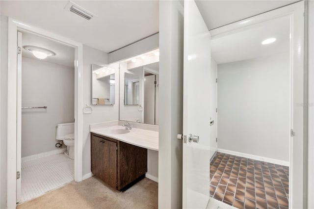 4006 Cypress Ln Unit 4006, Tampa, FL 33618 - bathroom featuring toilet, baseboards, vanity, and tile patterned floors