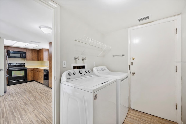 4006 Cypress Ln Unit 4006, Tampa, FL 33618 - laundry area with washer and dryer and light wood-style floors