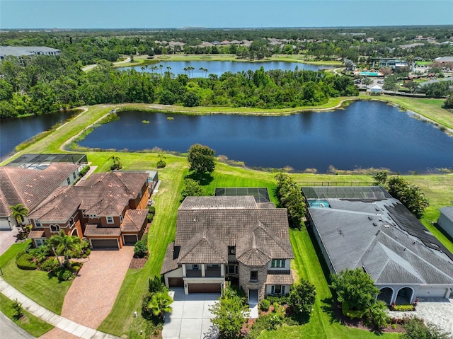 drone / aerial view of a large body of water and a tree filled landscape