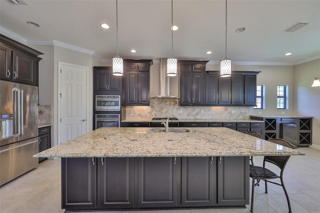 kitchen with high end refrigerator, a sink, wall chimney range hood, recessed lighting, and backsplash