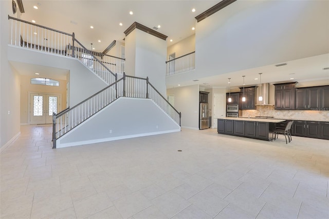 unfurnished living room featuring a high ceiling, french doors, stairs, baseboards, and recessed lighting