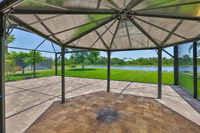 unfurnished sunroom featuring a water view and vaulted ceiling