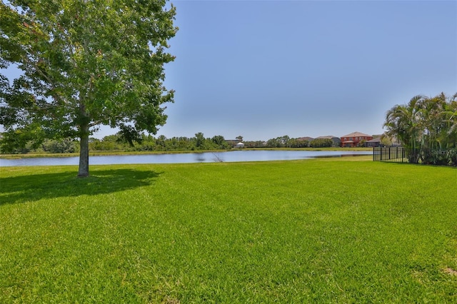 view of grassy yard with a water view
