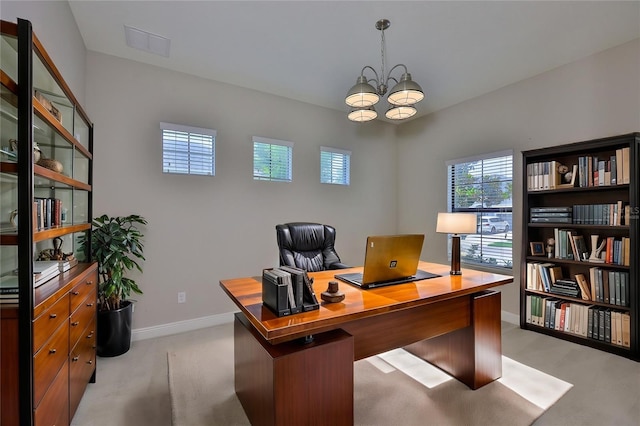 office featuring light colored carpet, a chandelier, and baseboards