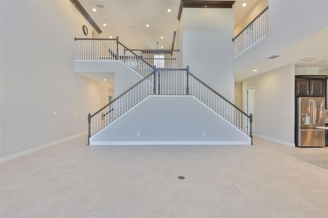 unfurnished living room featuring a high ceiling, stairs, baseboards, recessed lighting, and tile patterned floors