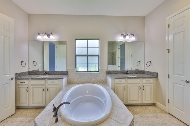 bathroom featuring two vanities, a bath, and a tile shower