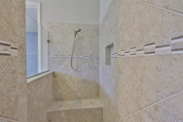 full bath with a tile shower