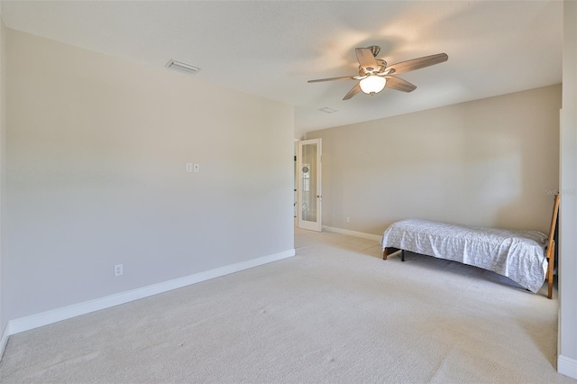 bedroom with light colored carpet, baseboards, and a ceiling fan