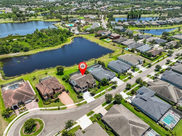 aerial perspective of suburban area featuring a nearby body of water