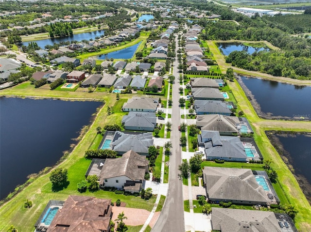 aerial view of residential area featuring a nearby body of water