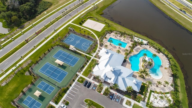aerial view of a pool area and a large body of water
