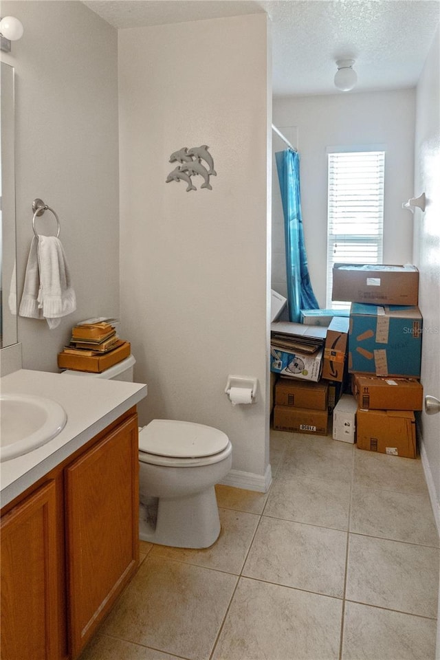 451 Peace Ct, Kissimmee, FL 34759 - bathroom with tile patterned flooring, vanity, toilet, a shower with curtain, and a textured ceiling