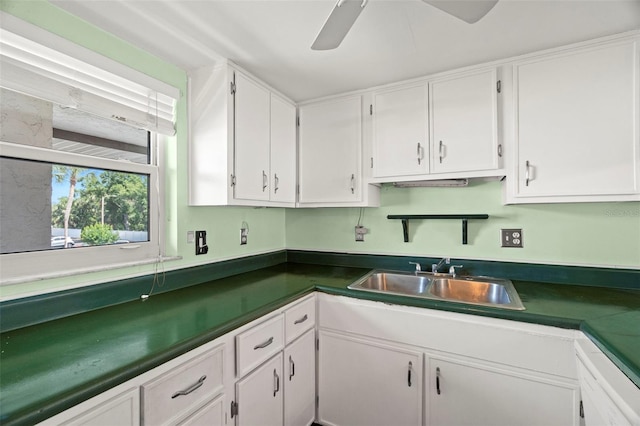 7701 Starkey Rd Unit 504, Seminole, FL 33777 - kitchen featuring white cabinetry, a sink, and dark countertops