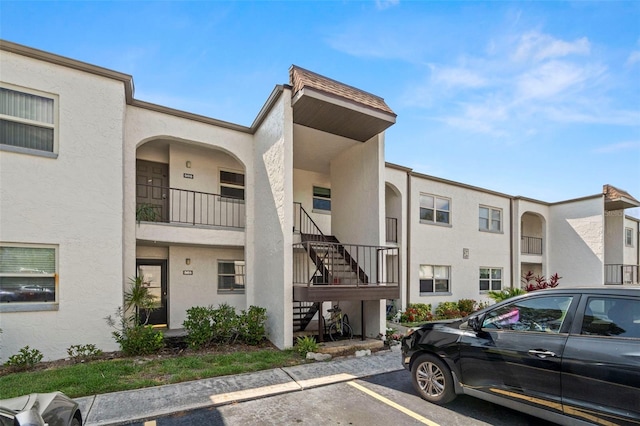 7701 Starkey Rd Unit 504, Seminole, FL 33777 - view of property with stairway and uncovered parking