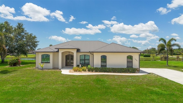 2484 SW 33rd Cir, Okeechobee, FL 34974 - view of front of property with stucco siding, a front yard, a metal roof, and a standing seam roof