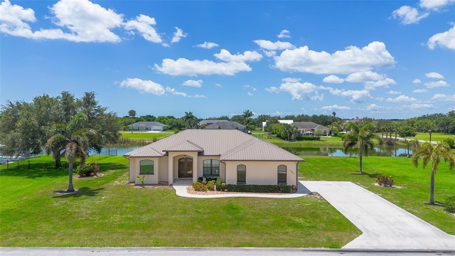 2484 SW 33rd Cir, Okeechobee, FL 34974 - mediterranean / spanish home with a water view, a front yard, and a metal roof