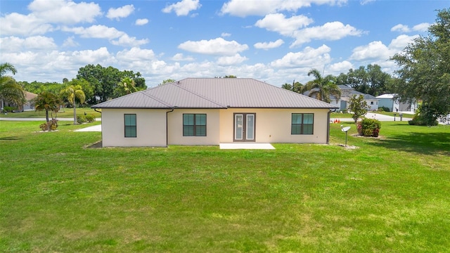 2484 SW 33rd Cir, Okeechobee, FL 34974 - rear view of property with stucco siding, a yard, and a metal roof
