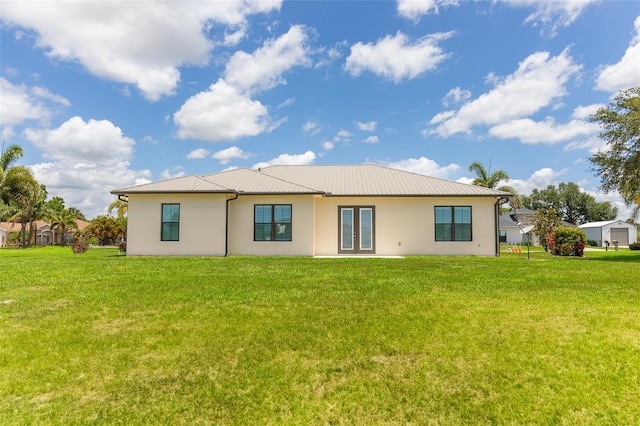 2484 SW 33rd Cir, Okeechobee, FL 34974 - rear view of property with french doors, stucco siding, and a yard