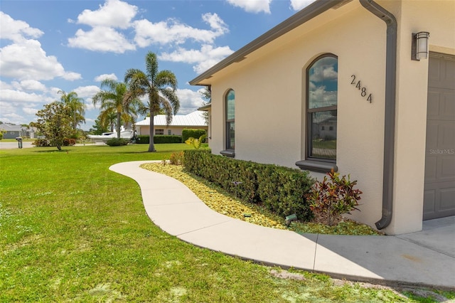 2484 SW 33rd Cir, Okeechobee, FL 34974 - view of side of property with a lawn and stucco siding