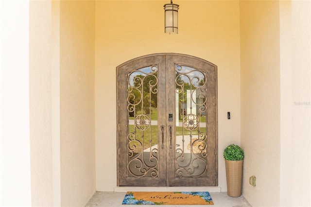 2484 SW 33rd Cir, Okeechobee, FL 34974 - view of exterior entry featuring french doors and stucco siding