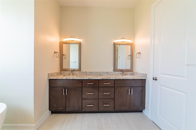 2484 SW 33rd Cir, Okeechobee, FL 34974 - bathroom with double vanity, wood finished floors, and a soaking tub