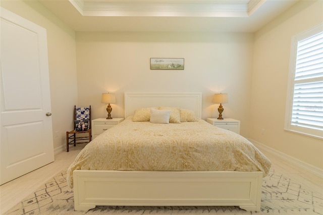 2484 SW 33rd Cir, Okeechobee, FL 34974 - bedroom featuring ornamental molding, multiple windows, a tray ceiling, and light wood-type flooring