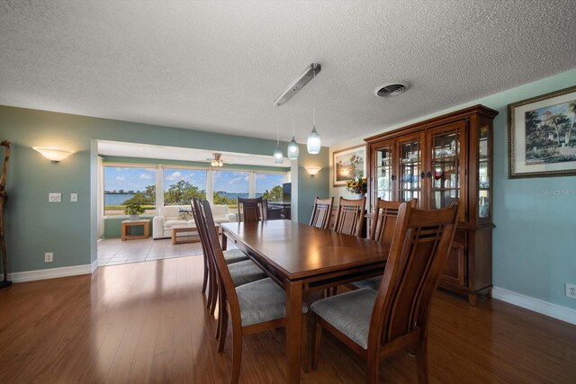 1963 Edgewater Dr, Clearwater, FL 33755 - dining room featuring baseboards, wood finished floors, a textured ceiling, and ceiling fan