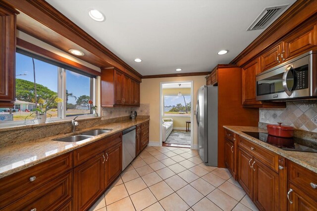 1963 Edgewater Dr, Clearwater, FL 33755 - kitchen with stainless steel appliances, a sink, tasteful backsplash, recessed lighting, and light tile patterned floors