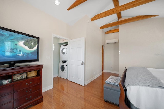 1963 Edgewater Dr, Clearwater, FL 33755 - bedroom with stacked washer and clothes dryer, an AC wall unit, beam ceiling, light wood-style flooring, and high vaulted ceiling