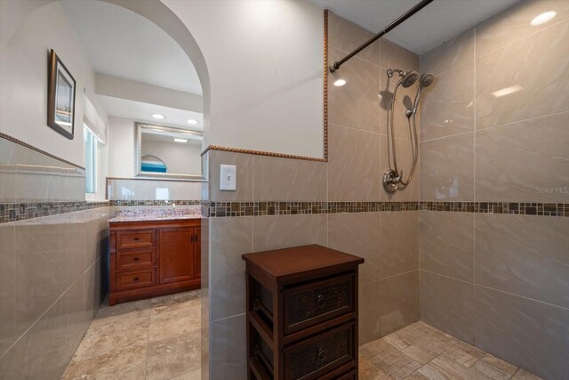 1963 Edgewater Dr, Clearwater, FL 33755 - full bath featuring tile walls, tiled shower, and vanity