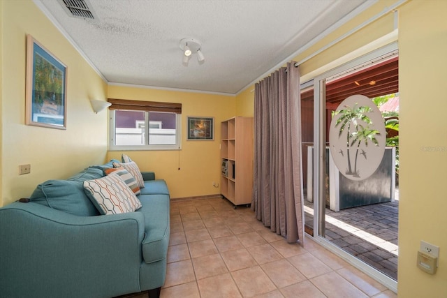1963 Edgewater Dr, Clearwater, FL 33755 - sitting room featuring crown molding, light tile patterned floors, a textured ceiling, and baseboards