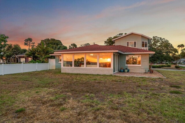 1963 Edgewater Dr, Clearwater, FL 33755 - back of property at dusk featuring a shingled roof