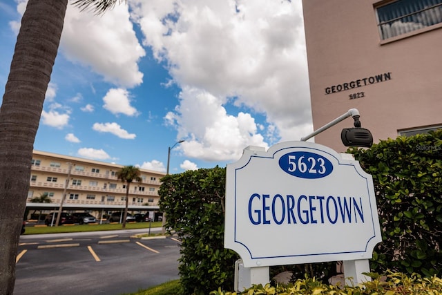 community sign with uncovered parking