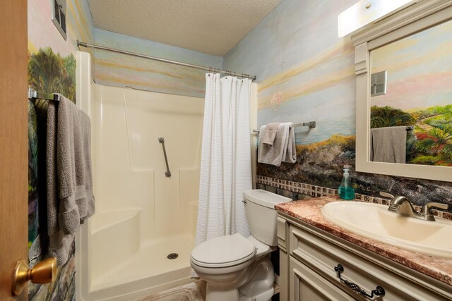 bathroom featuring a shower with shower curtain, toilet, a textured ceiling, and vanity