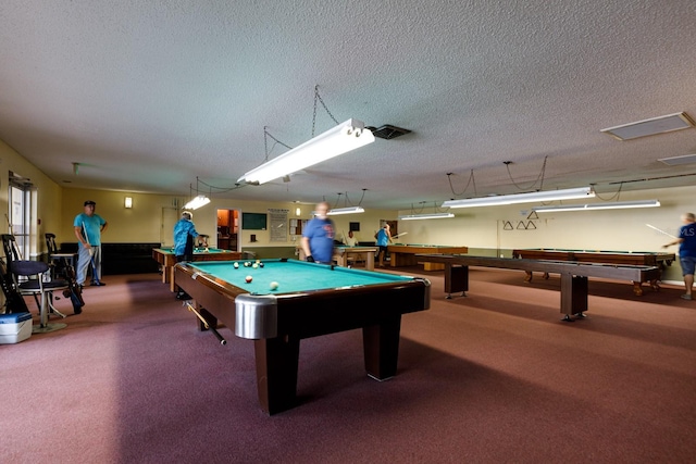 rec room with billiards table, a textured ceiling, and carpet floors