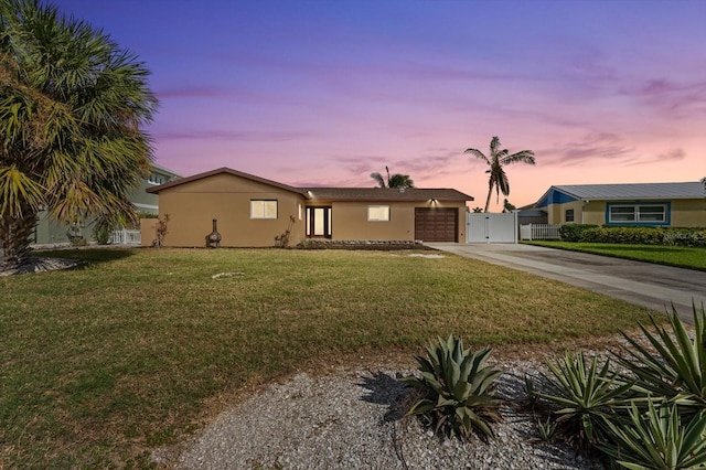 5108 Commonwealth Rd, Palmetto, FL 34221 - ranch-style house featuring concrete driveway, an attached garage, a gate, and stucco siding