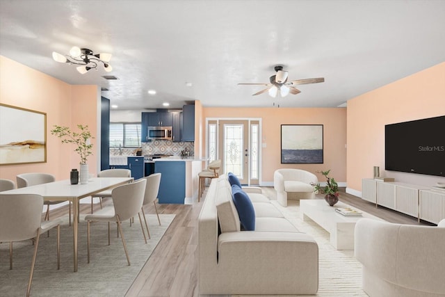 5108 Commonwealth Rd, Palmetto, FL 34221 - living room with light wood-style flooring, plenty of natural light, ceiling fan, and baseboards
