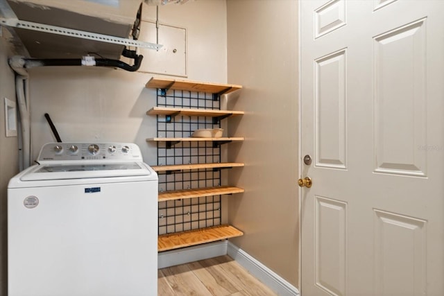 5108 Commonwealth Rd, Palmetto, FL 34221 - washroom with washer / dryer, baseboards, and light wood-style flooring