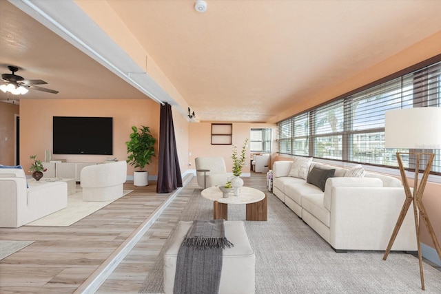 5108 Commonwealth Rd, Palmetto, FL 34221 - living room featuring a ceiling fan, light wood finished floors, and baseboards