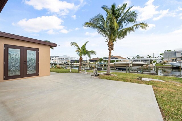 5108 Commonwealth Rd, Palmetto, FL 34221 - view of patio with boat lift, french doors, a boat dock, and a water view