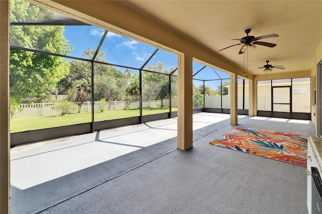 unfurnished sunroom featuring ceiling fan