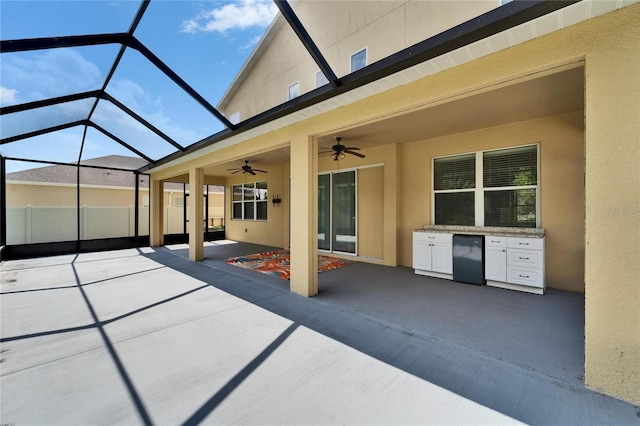 view of patio / terrace featuring ceiling fan and a lanai