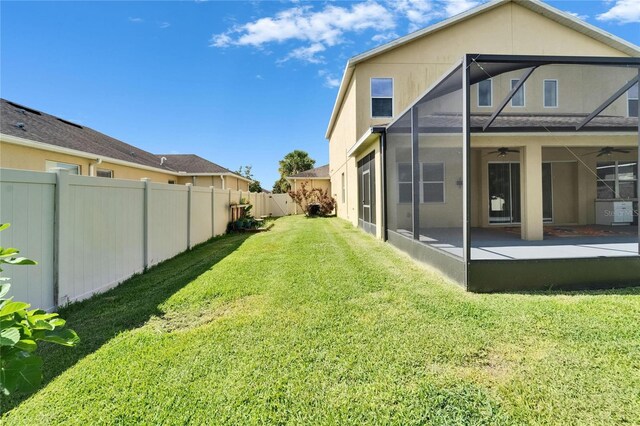 back of property featuring a ceiling fan and a patio area