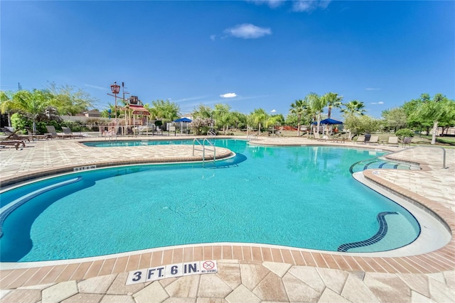 community pool featuring a patio area